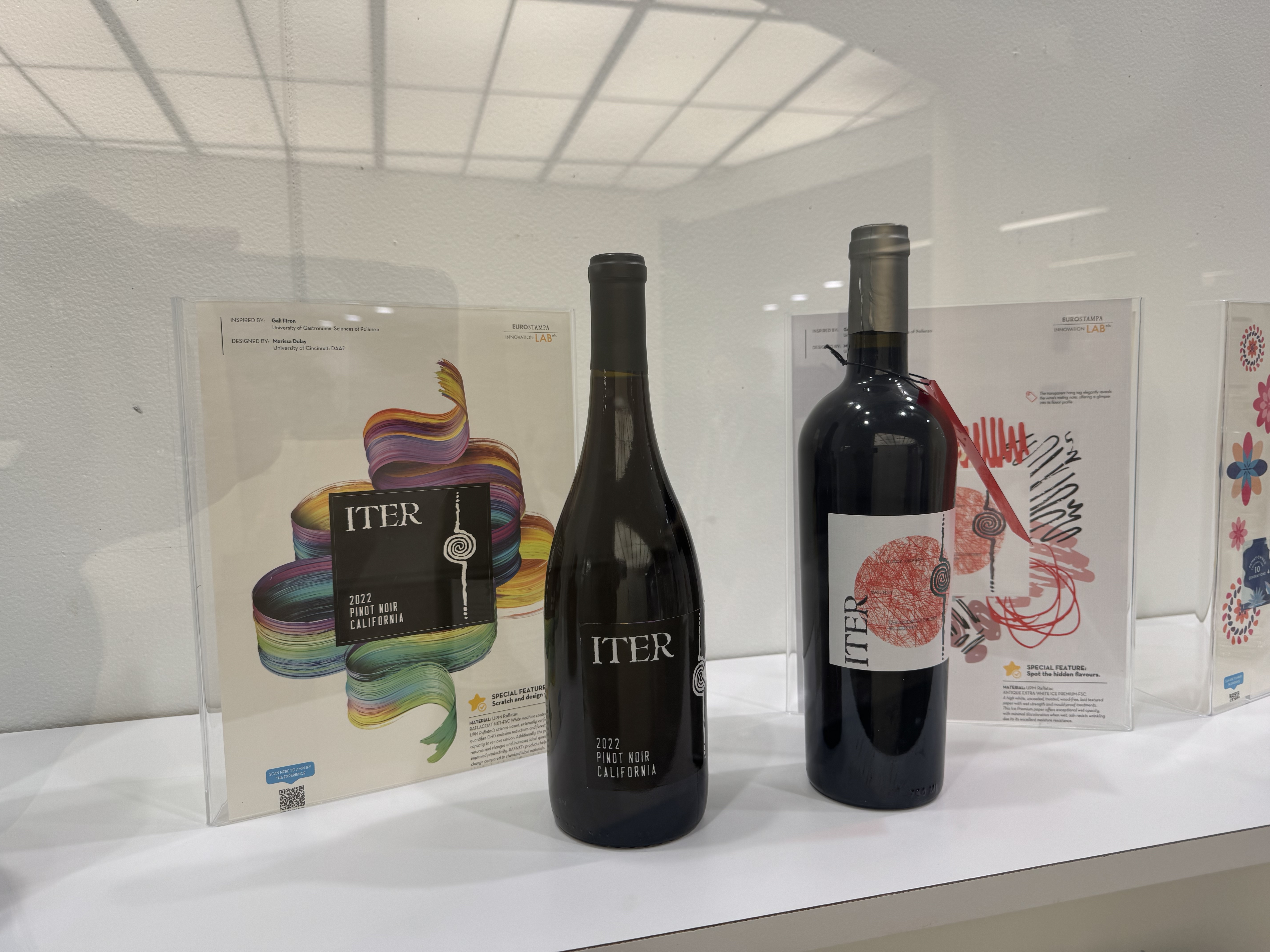 Close up of two wine bottle items on display