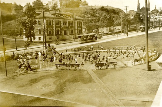 Children playing in a water feature in a Cincinnati park, dated circa 1910s or 1920s
