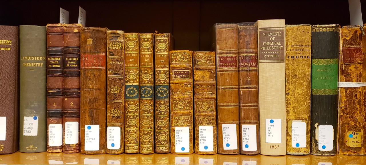Close up of a shelf of old books from the Oesper rare book collection