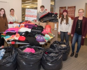 Volunteers sort Spread the Warmth donations.